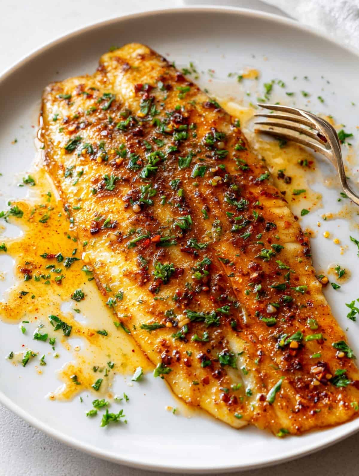 flaky baked basa fillets in a plate