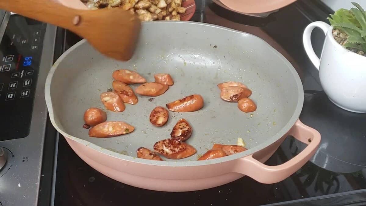 Andouille sausage browning in pot