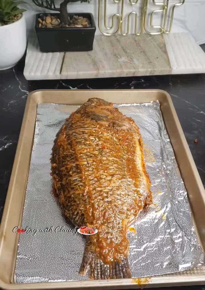 marinated whole tilapia in a baking tray