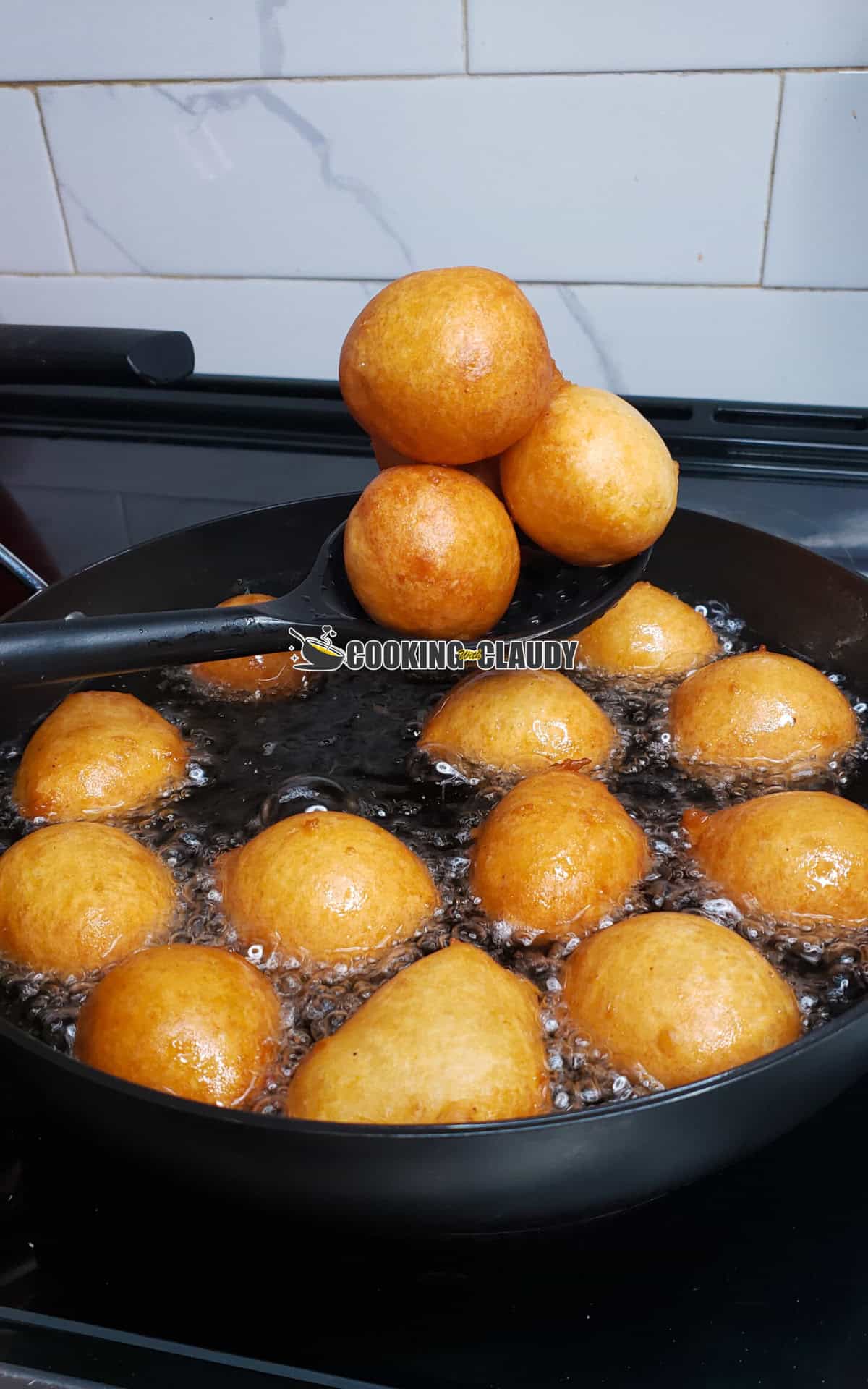 puff puff in a spoon above a pot
