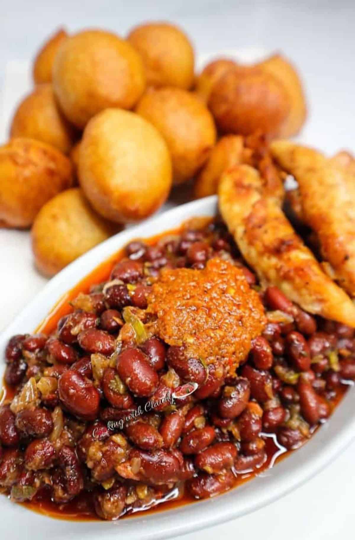 puff puff served with beans in a white bowl