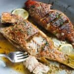 flaky pan seared whole fish in a skillet