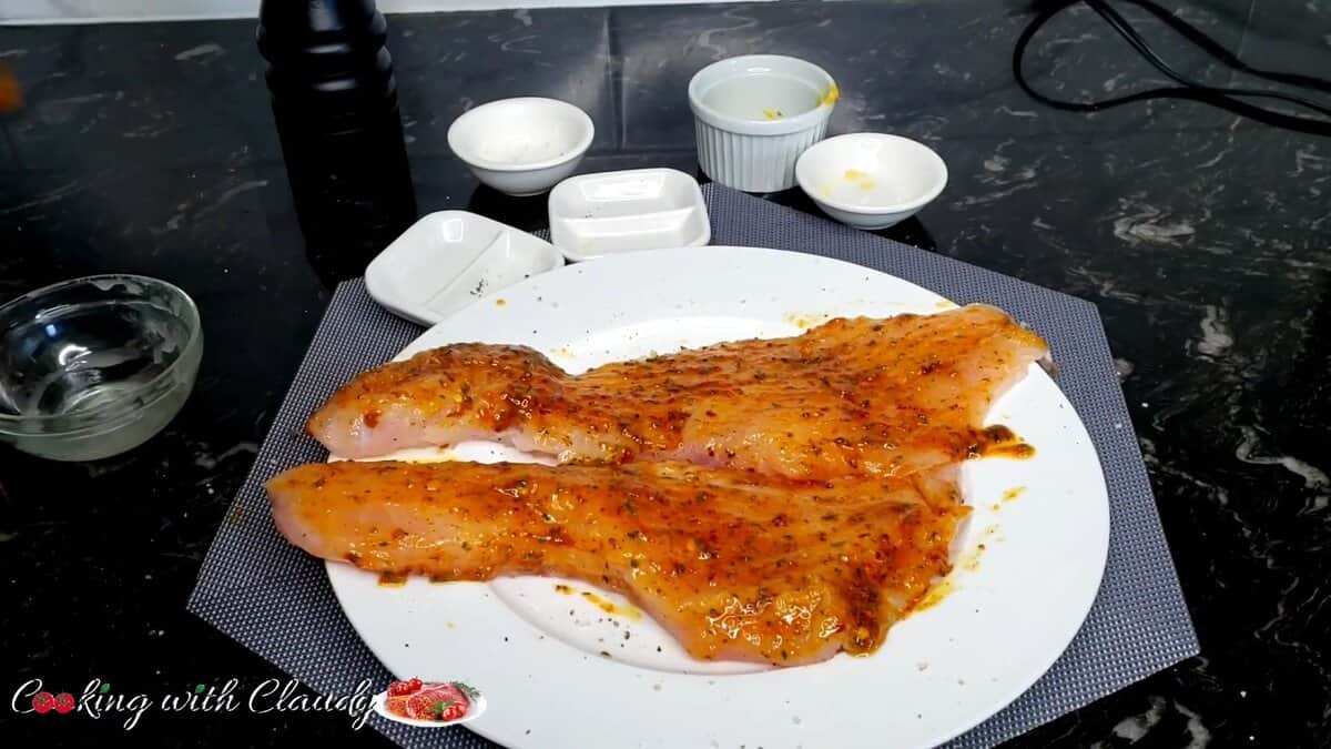 Rub each red snapper fillet with garlic, lemon juice, mustard, honey, salt, and pepper. 