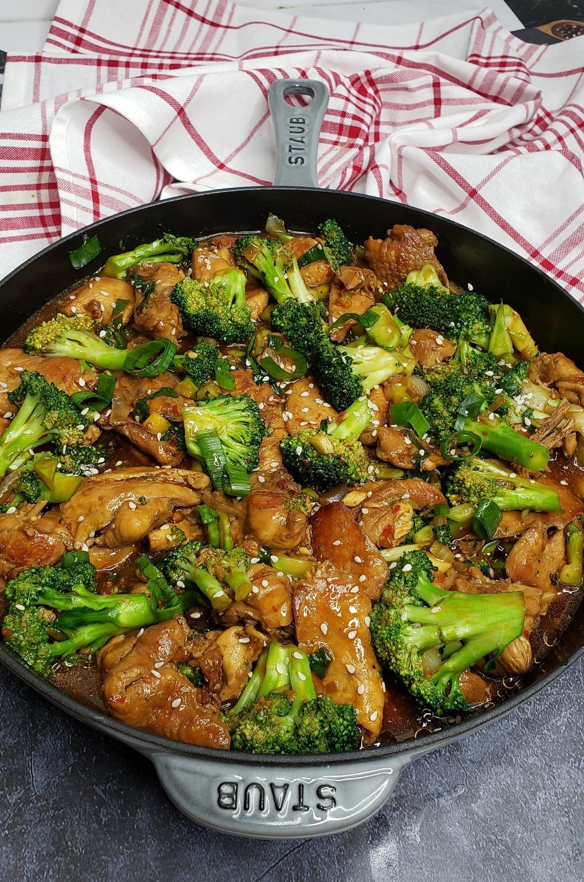 chicken and broccoli stir fry in a skillet