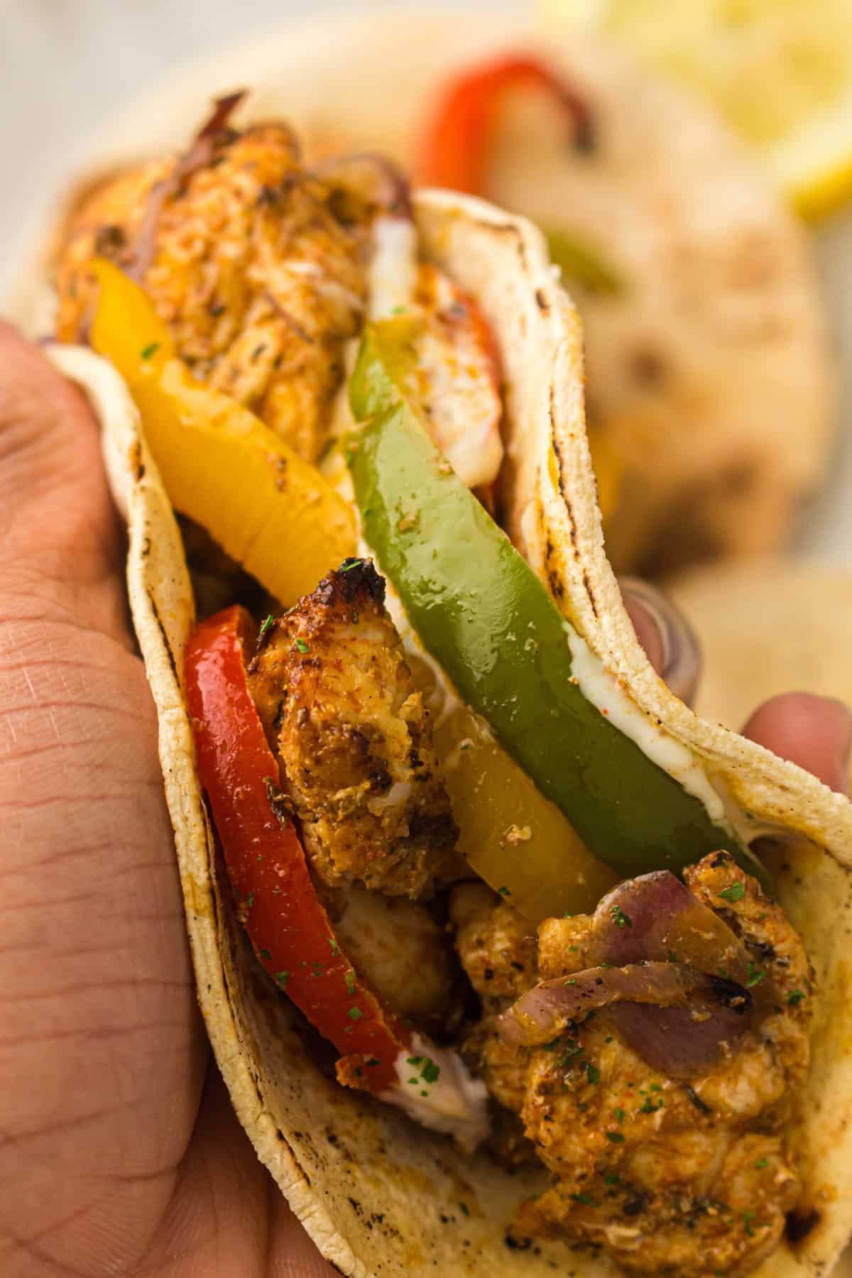 hand holding air fried fajitas