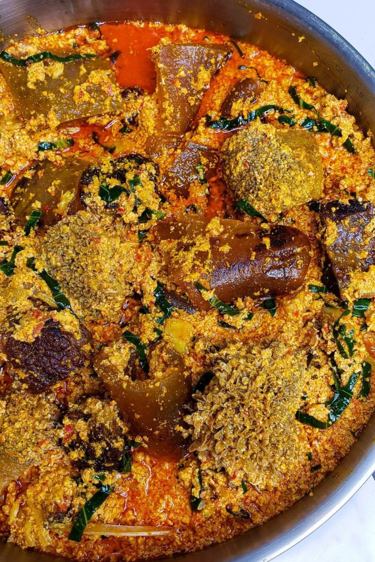egusi soup in a stainless steel pot